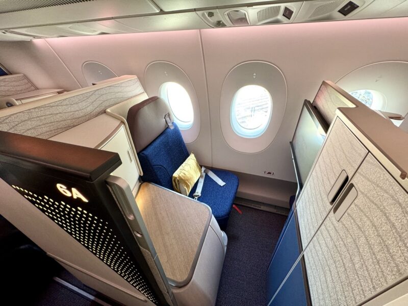 a seat and a chair in an airplane