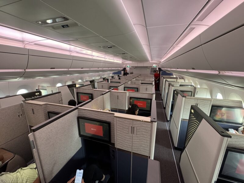 a room with cubicles and people in it