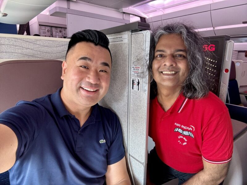 two men sitting in an airplane