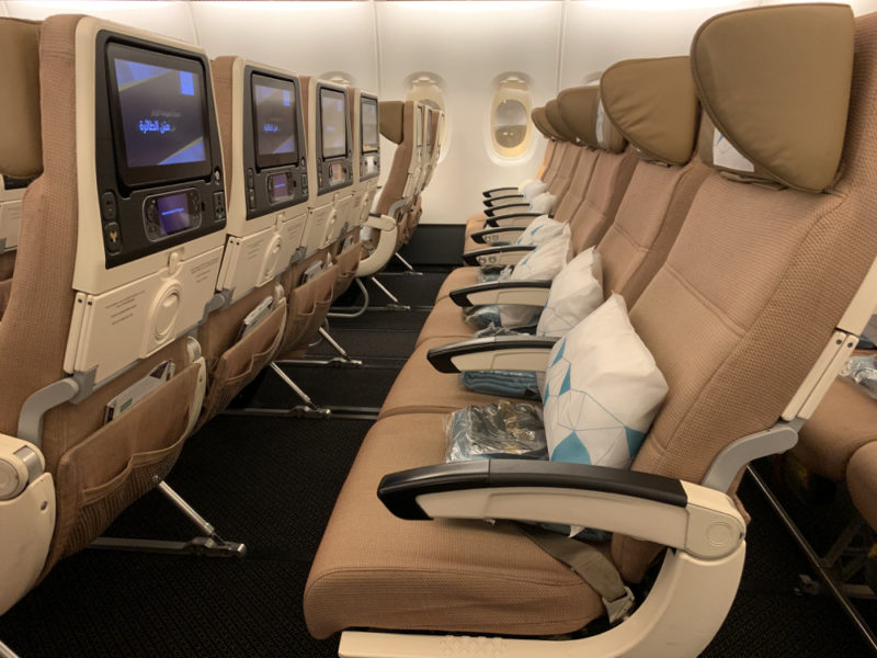a row of seats with monitors on the side