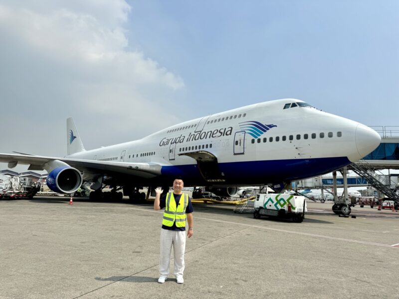 a man standing in front of a large airplane