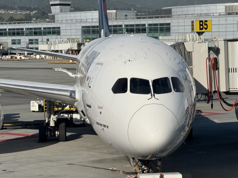 a white airplane parked at an airport