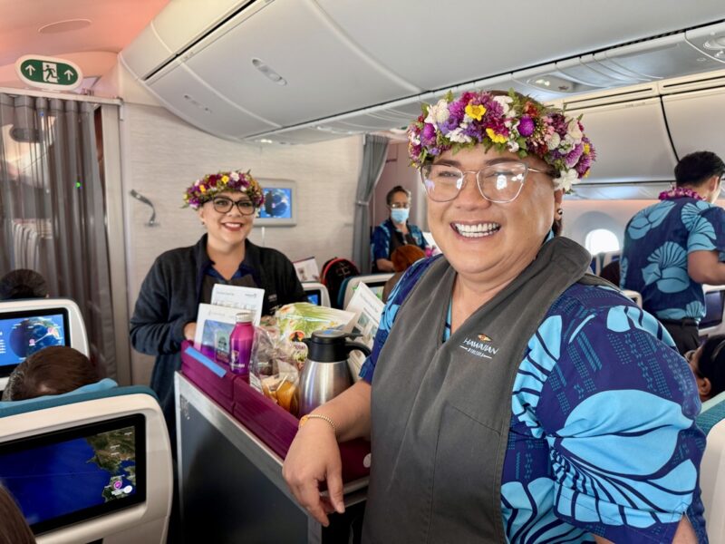 a woman wearing flowers on her head smiling