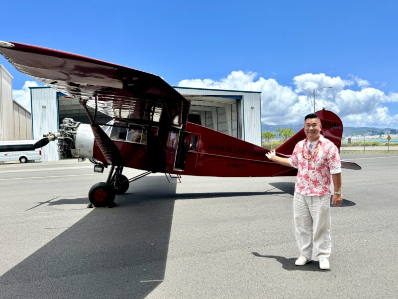 a man standing next to a small plane