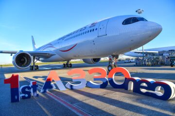a large white airplane on a runway
