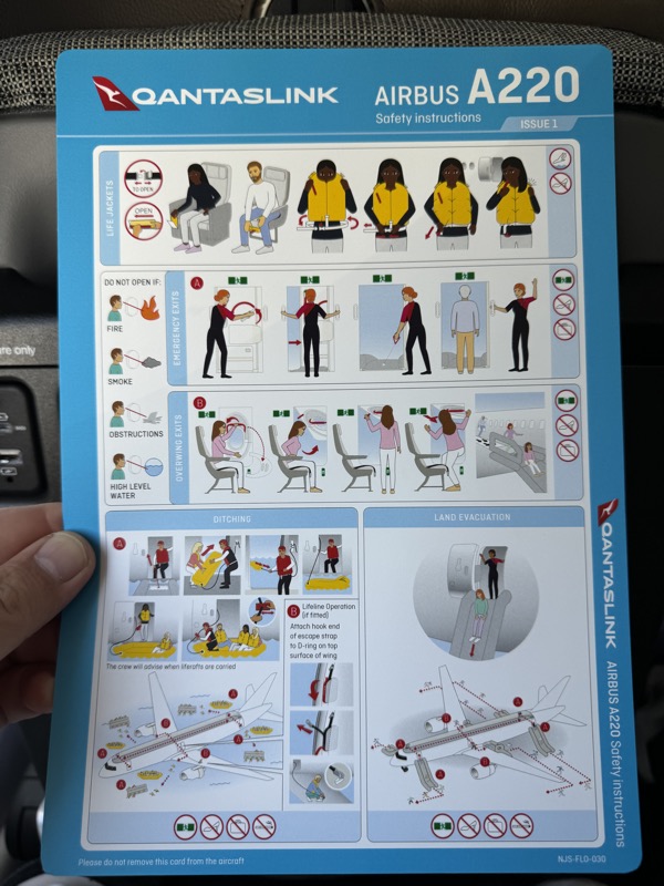 a hand holding a instruction booklet