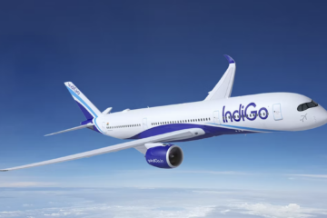 a white and blue airplane flying in the sky